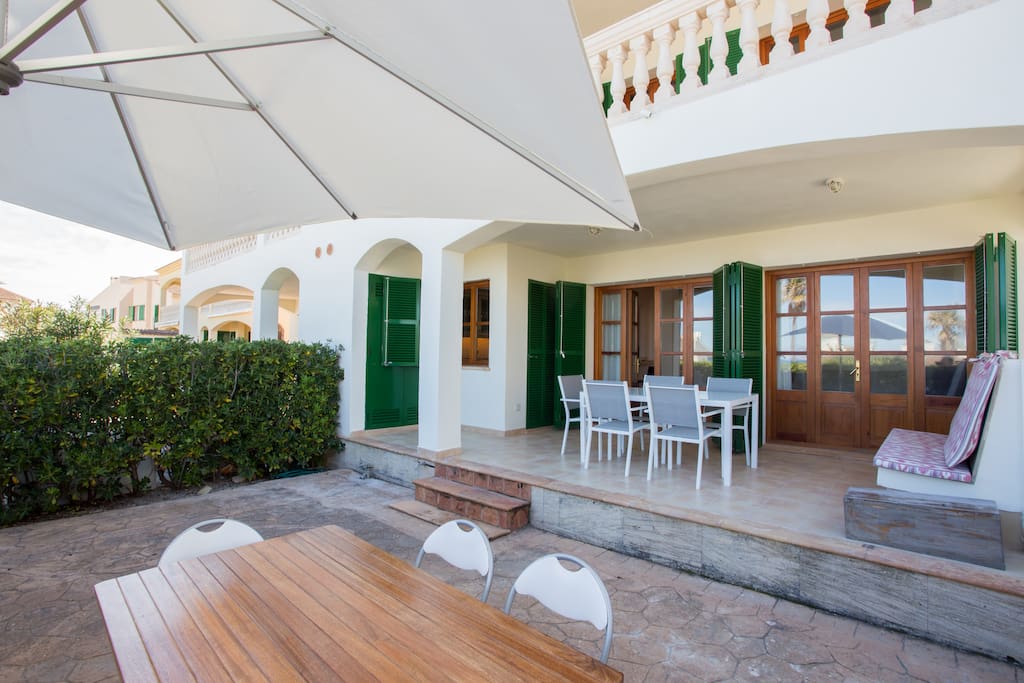 Spacious private terrace space with 2 dining tables under shade and sun.