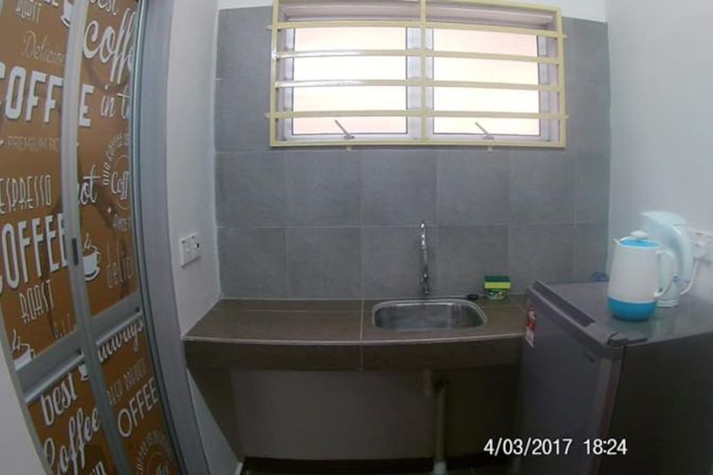 A kitchenette with a real fridge