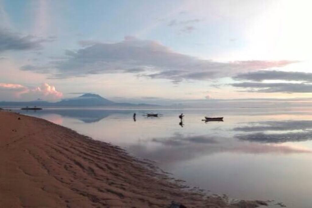 Sanur sunrise with low tide with view of the biggest Bali volcano mount Agung