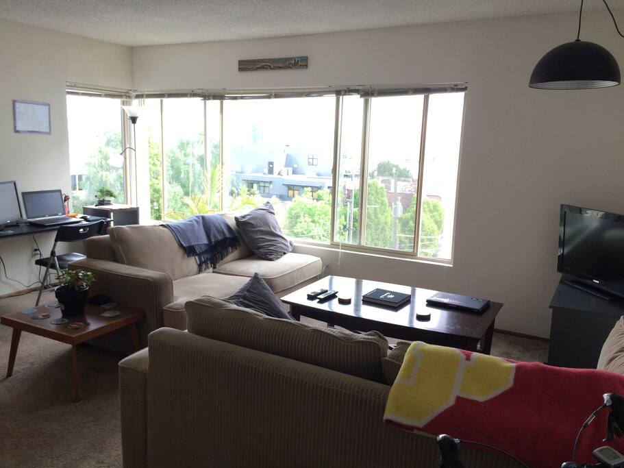 Living room with two large and very sleepable couches with TV and desk