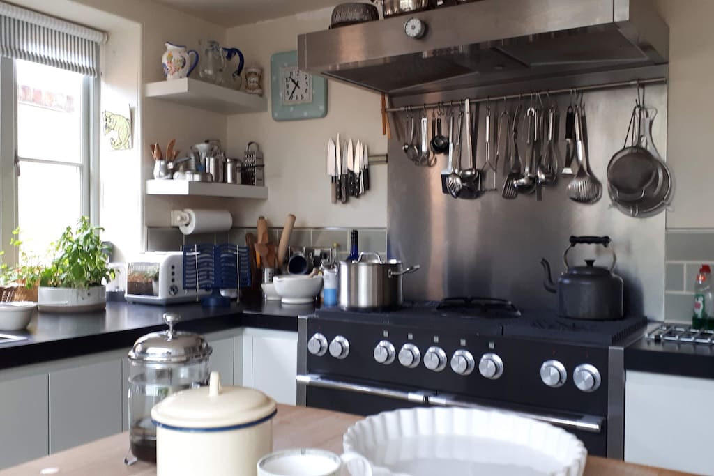 A smart well-equipped kitchen with Mercury cooker, Franke stainless steel sink and Miele fridge.Plenty of storage, a sturdy work island and a larder with marble shelves.There is a step up into the dining room with access to the walled garden beyond.