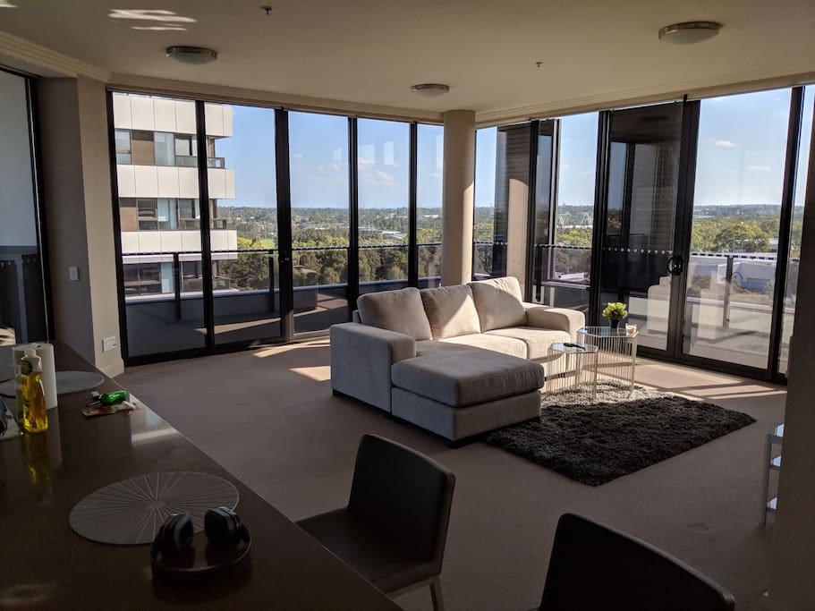 blinds up, spacious living room side angle