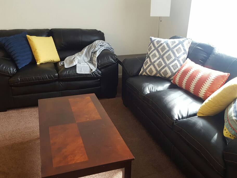 Colorful accent pillows, a throw blanket and big windows brighten up the space.
