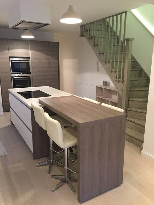 Modern open plan kitchen and hand painted staircase