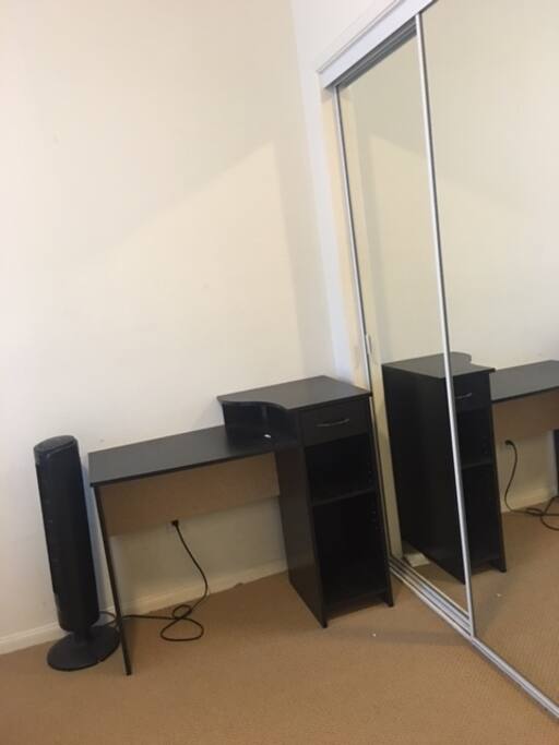 Small desk and closet in room