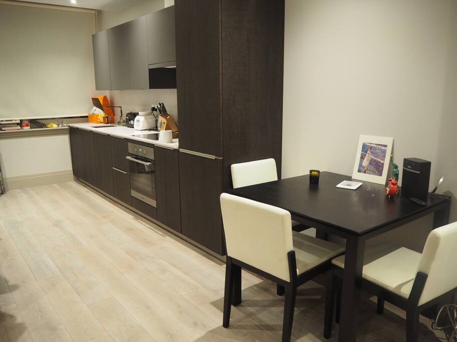 Modern kitchen, washing machine, dish washer and dining table