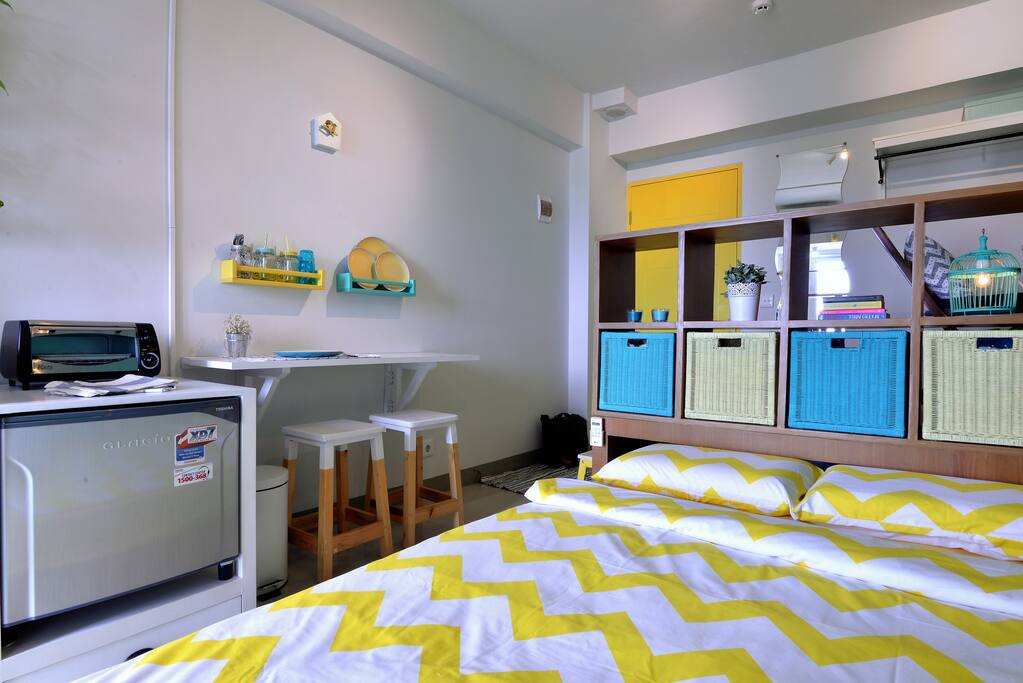 Queen sized bed in full size, the foldable dining table in use