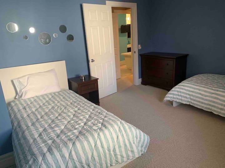 3rd bedroom with 2 twin beds, a dresser and closet. Extra pack and play and toys for kids are in this room