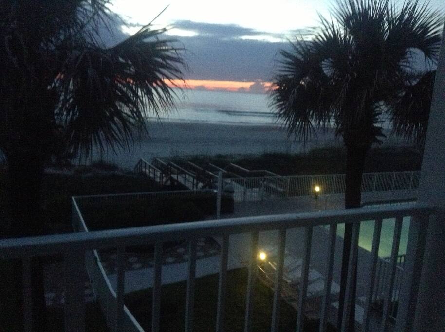 View of the beach from the balcony at sunset.