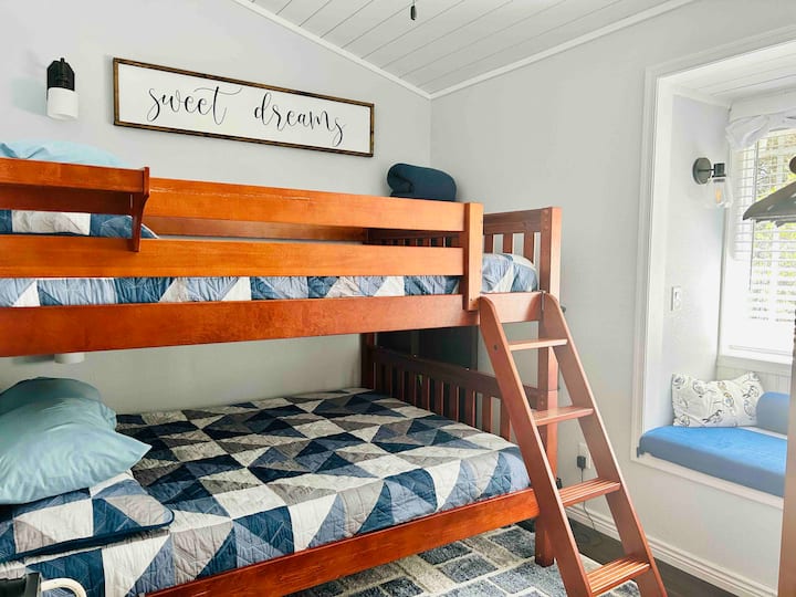Queen bunk beds in the second bedroom.  Comfy window seat provides the perfect place to relax and read. 