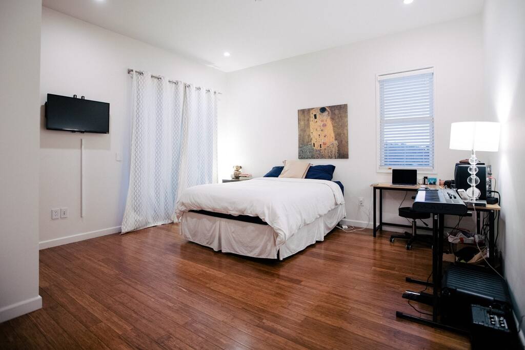 Full room with TV, closet, bed, desk, chair