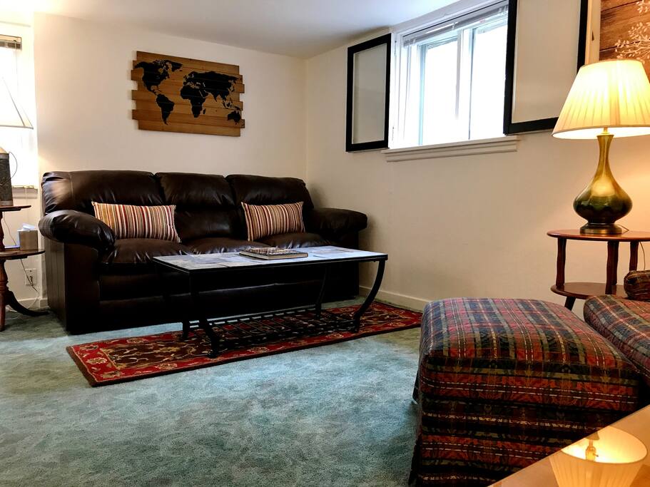 Living room with leather couch and fabric upholstered chair