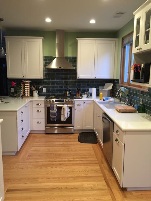 Remodeled kitchen features updated cabinets and appliances.