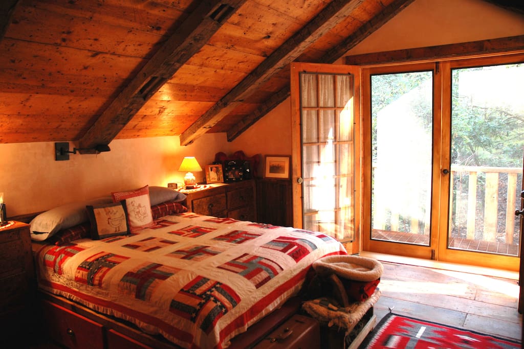 Loft bedroom with balcony looking out to National Forest and trails, 1/2 bath (bath with shower downstairs)