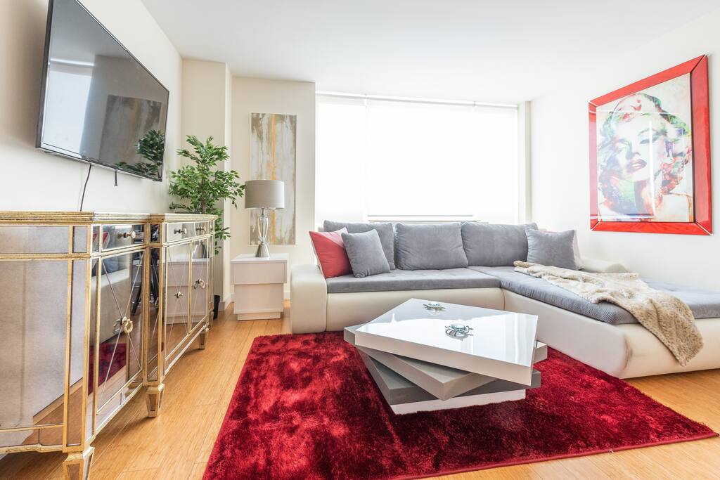 Spacious living room, a large comfortable couch and floor to ceiling windows