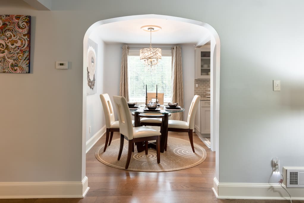 Seating for 4 in the dining area with a glass table, leather chairs and a great view of the park-like backyard.