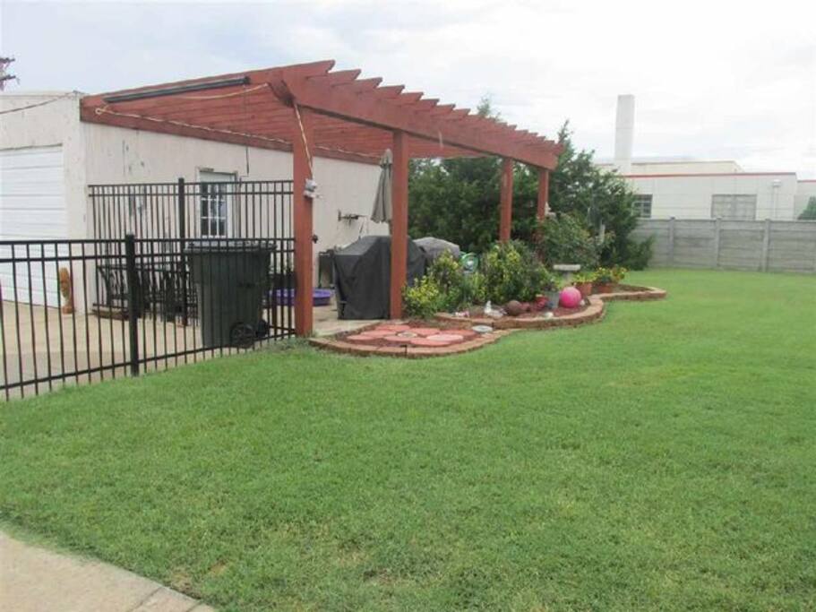 Patio w/barbecue grill and shop.