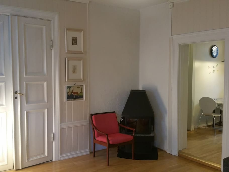 Fireplace in living room. Kitchen in the background
