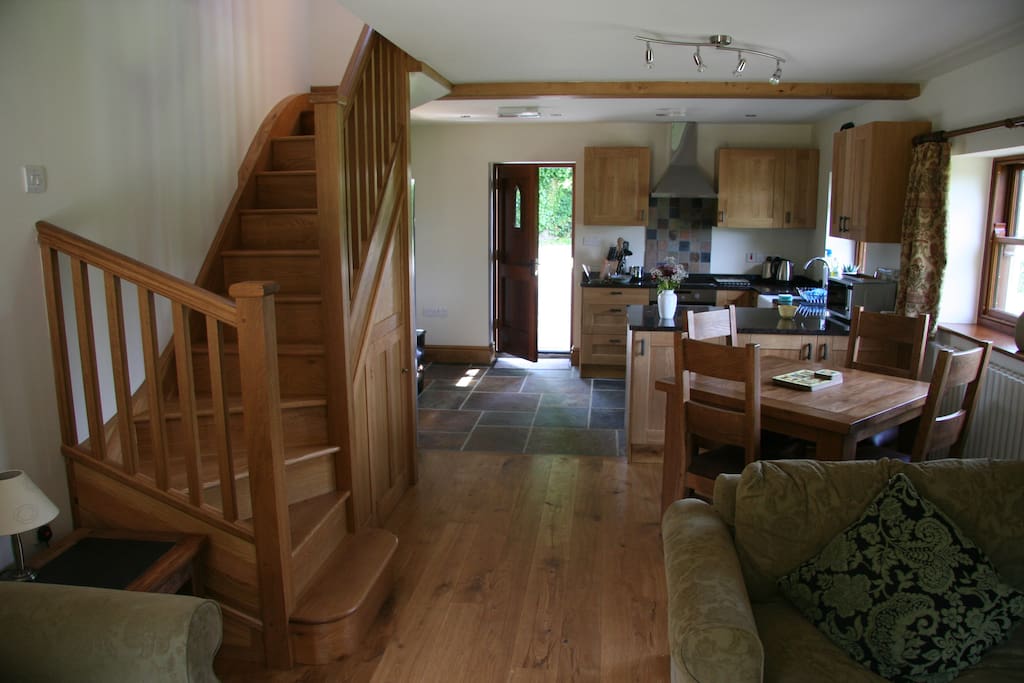 Spacious open plan lounge/diner with handmade oak staircase.