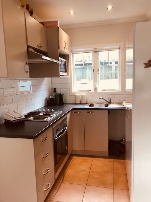 Kitchen with oven, microwave, Nespresso machine, toaster and kettle