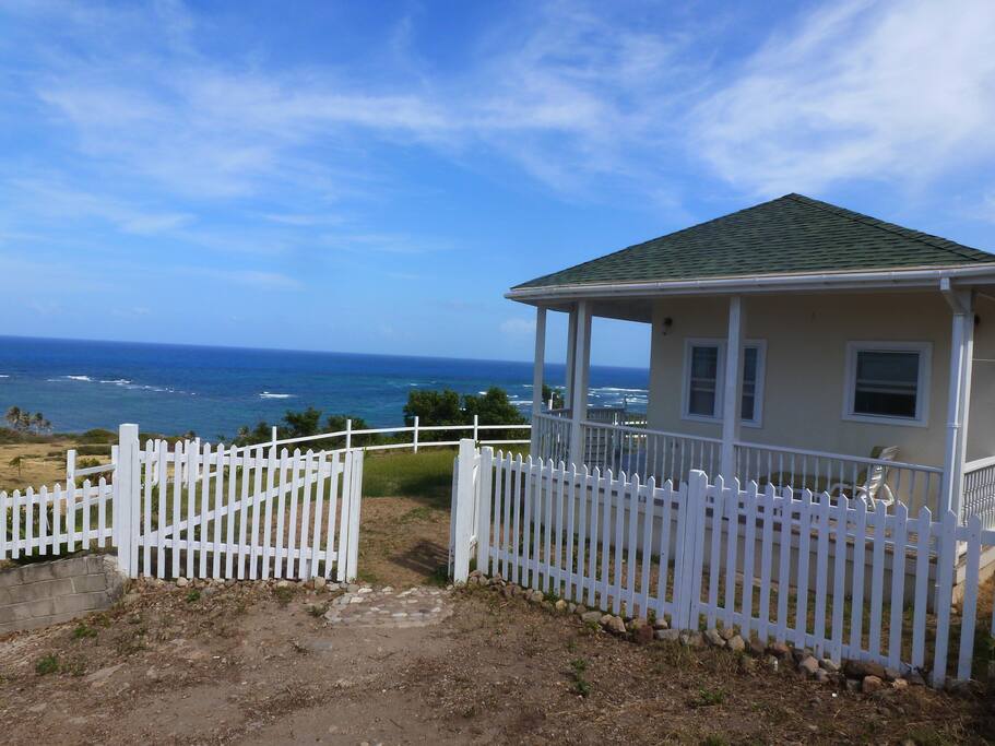 Picket fence entrance to cottage from parking area
