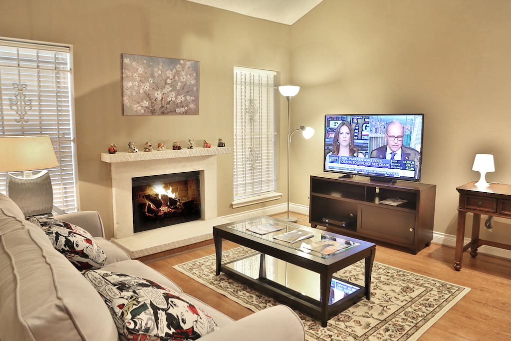Living room with TV and fireplace.