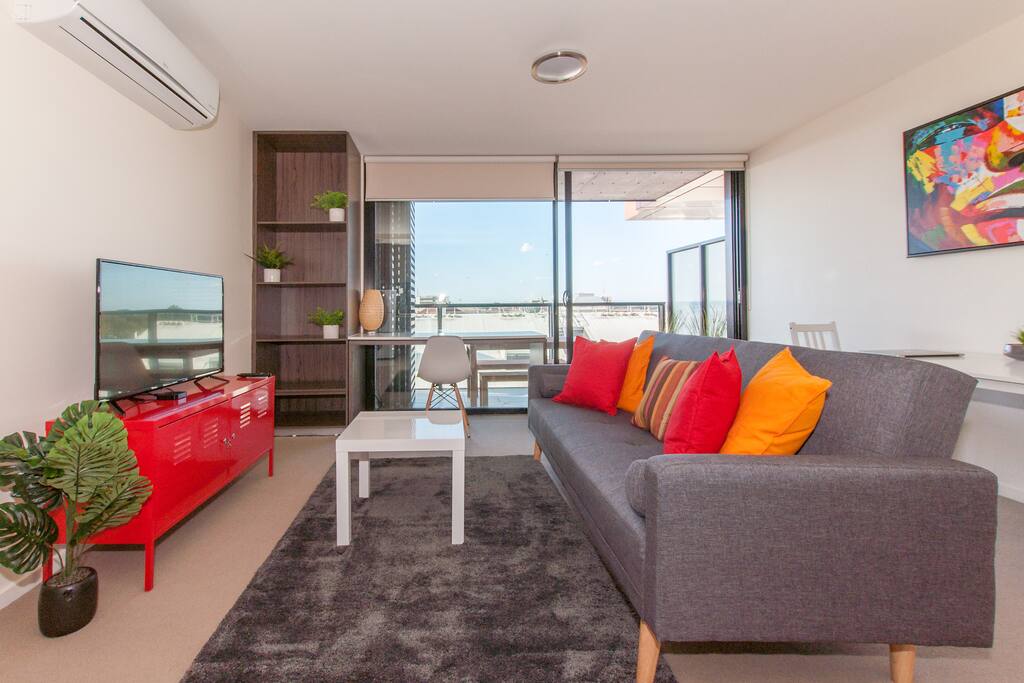 The living area includes a three-seater couch, and TV with Netflix