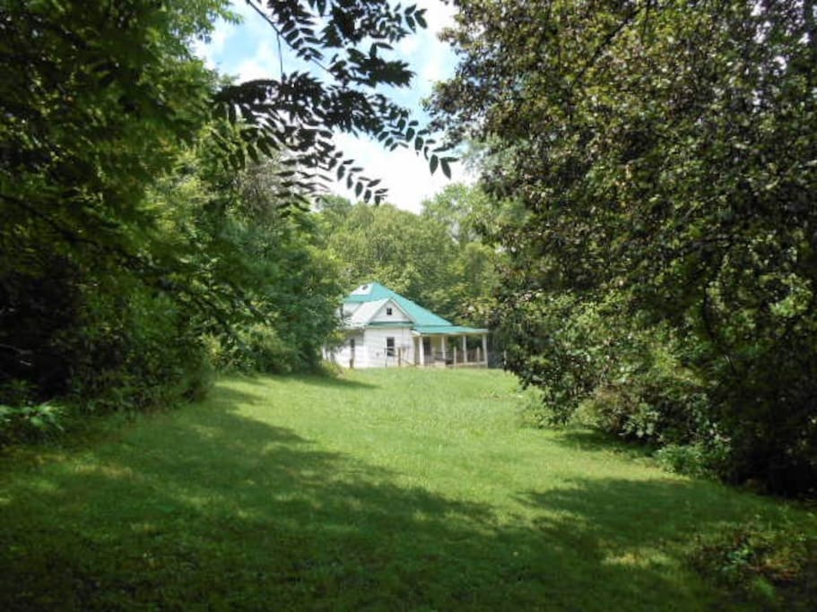 Roam your hideaway on an acre of lawns and woods, bordered by two creeks
