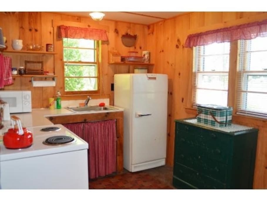 Kitchen includes stove, fridge,microwave, coffee pot, and plenty of pots and pans. We ask you use paper plates to reduce on water use.