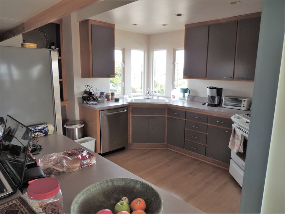 Sunny, well appointed kitchen. Combined with adjacent dining room with views, you won't want to "go out" for meals.