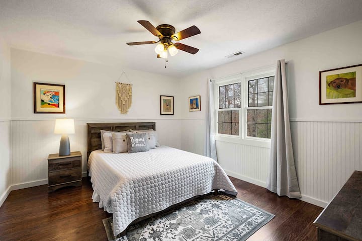 Upstairs bedroom 2 with queen bed, dresser, and walk in closet