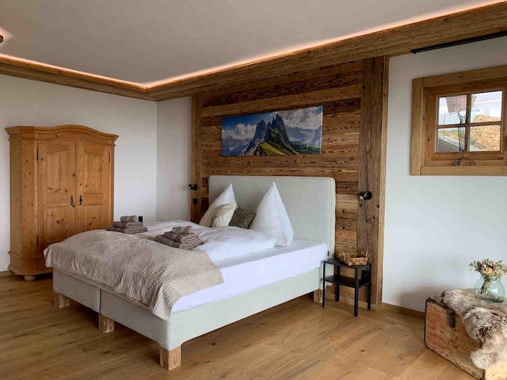 Bedroom 1 on the basement floor with large sliding glass door to the garden 