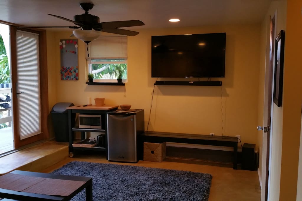 60" television with sound bar system, and DVD.