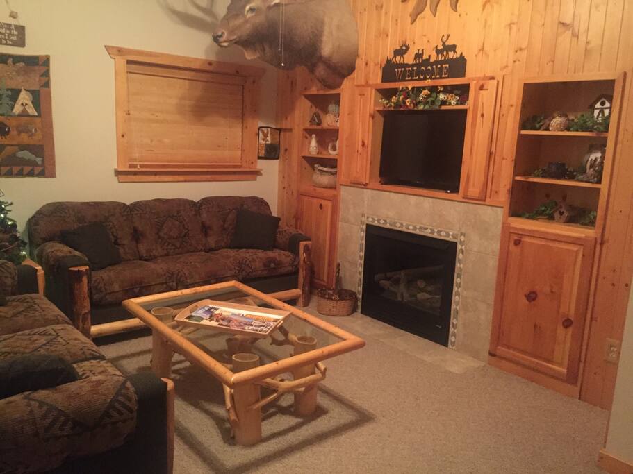 Cozy living room with fireplace and roku smart tv.