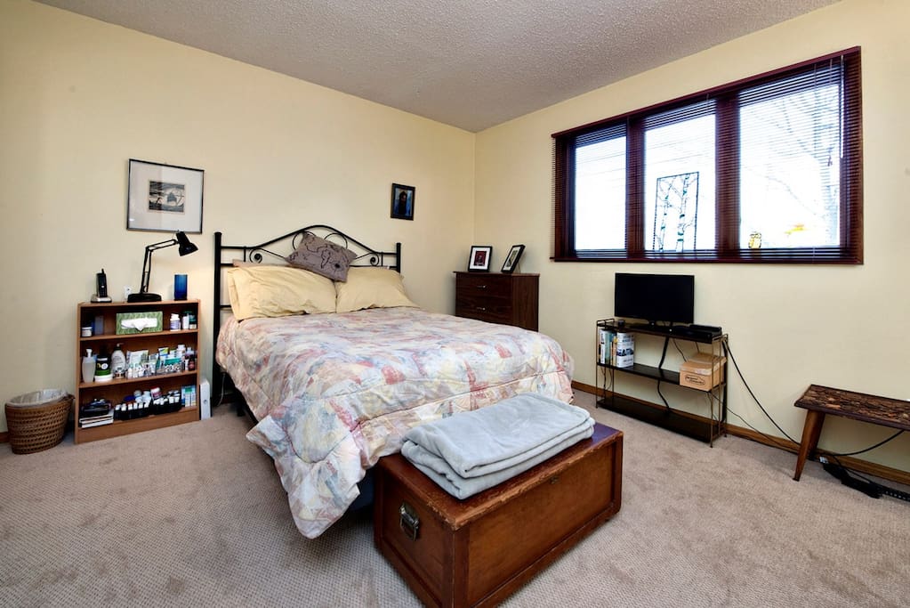 The bed how has a spring-box base. A large corner desk has been added.