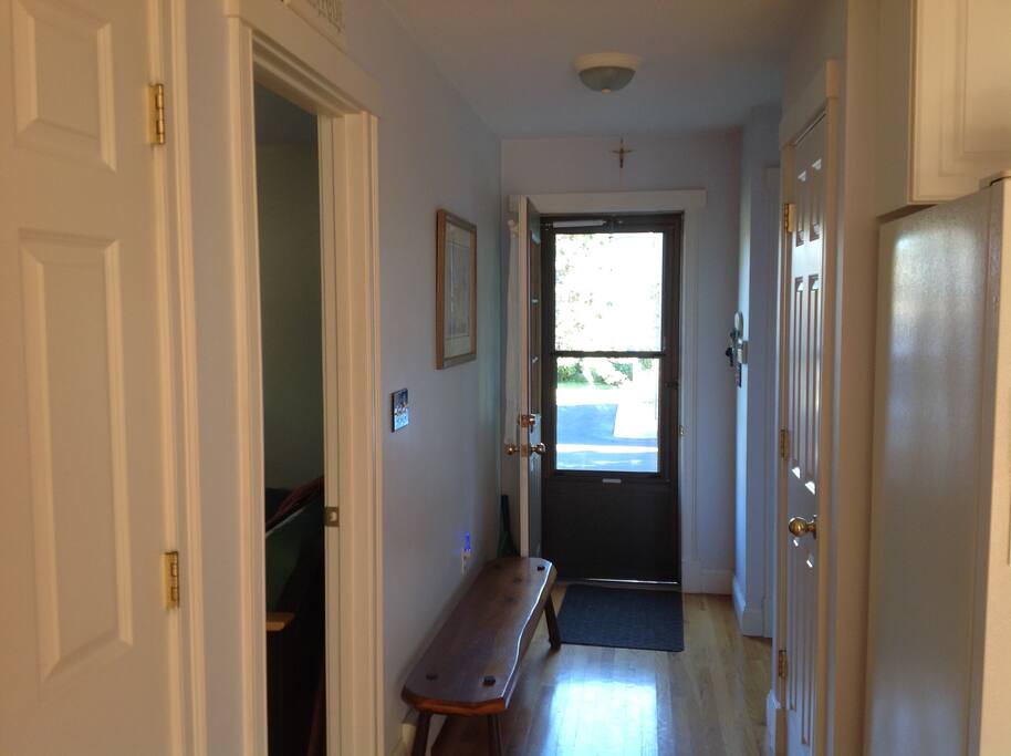 Side entry way into a large open kitchen/dining area.