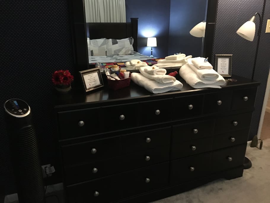 Full sized dresser stocked with extra towels, hair dryer, and other essentials