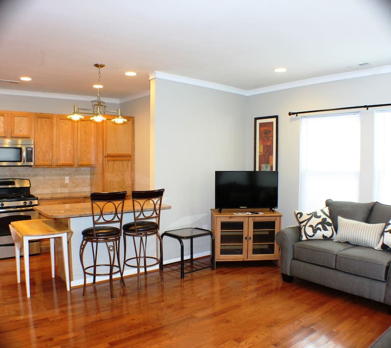 There is a dining room table to the left of the counter.