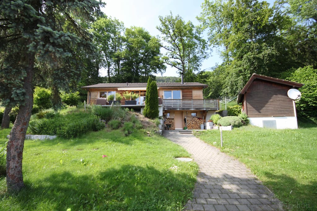 House surrounded by a large garden with a small detached house