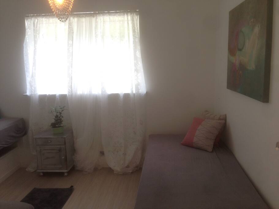 A bedroom with 3 beds