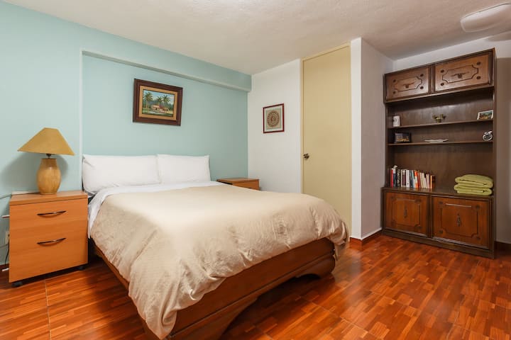 View of the suite bedroom, with full bathroom.