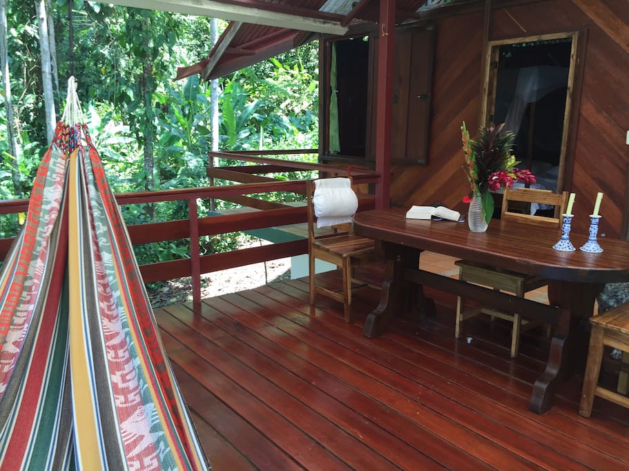 Covered Patio with dining area and hammock