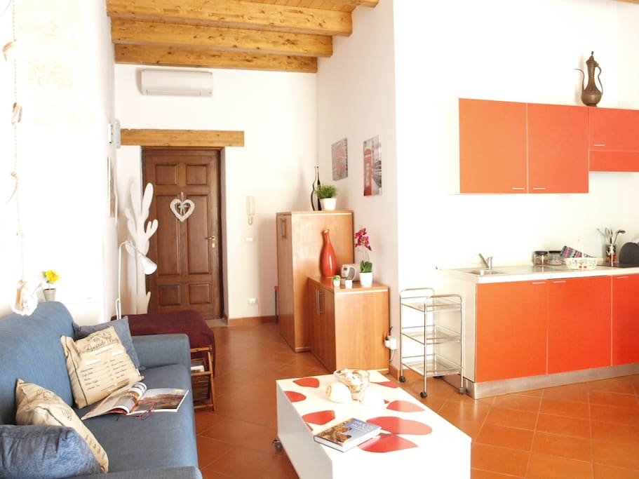 the spacious living room - view on the entrance door and on the kitchen