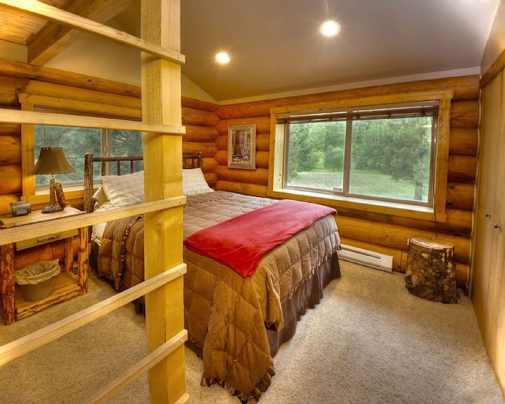 Lumberjack room featuring a queen-size hickory log pole bed and loft bed.