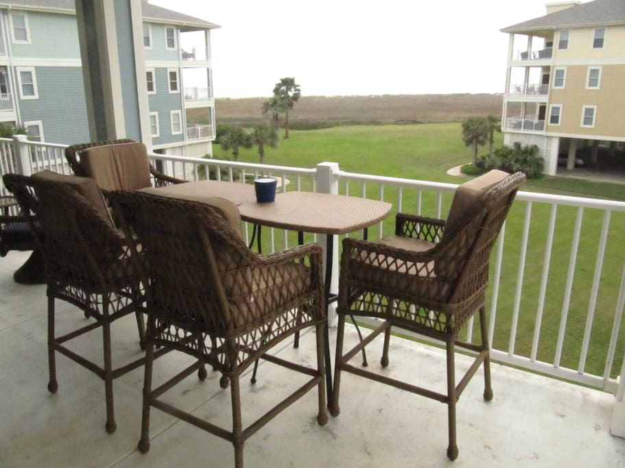 View of the gulf from the 2nd floor. Pub Height chairs allow you to look at the beach and not the spokes in the railing. Seating for 6 is provided.