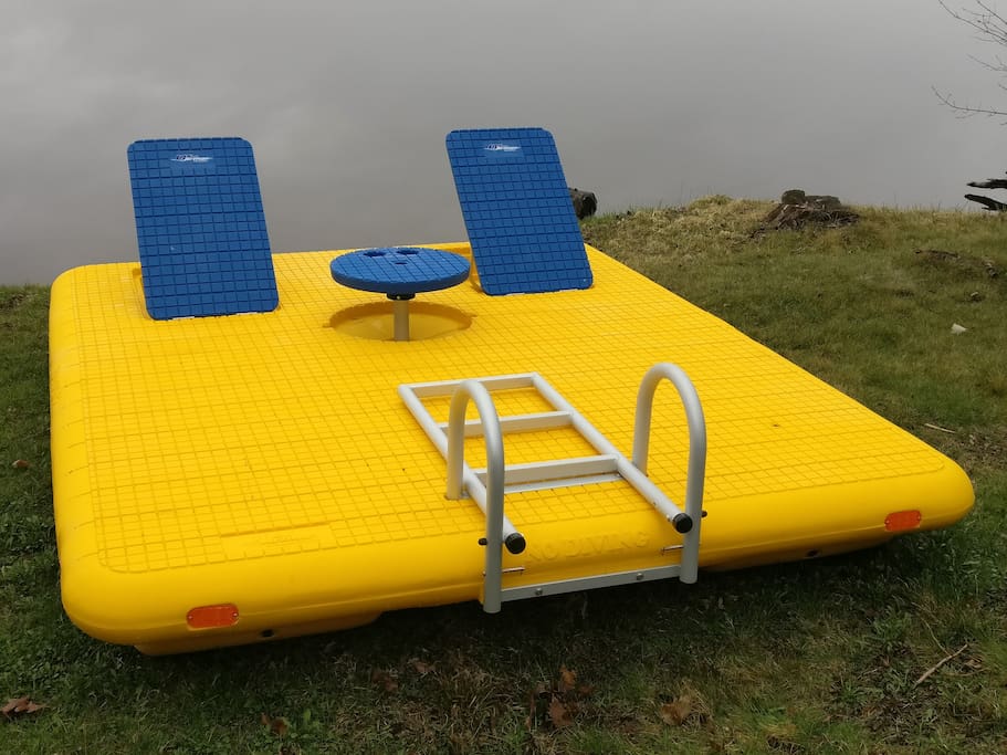 New swimming raft with table, ladder, back rest and anchor.