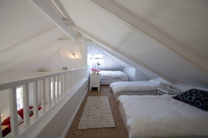 Loft bedroom with king bed and two singles