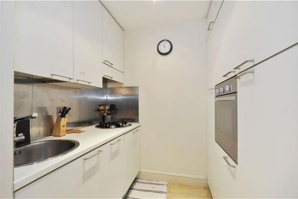 Kitchen, with dishwasher, oven, fridge, extractor fan.