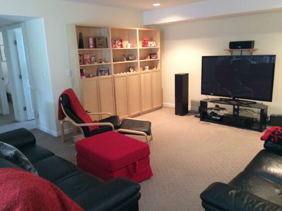 Relaxing lounge area downstairs showing hallway to private bathroom and bedroom.
