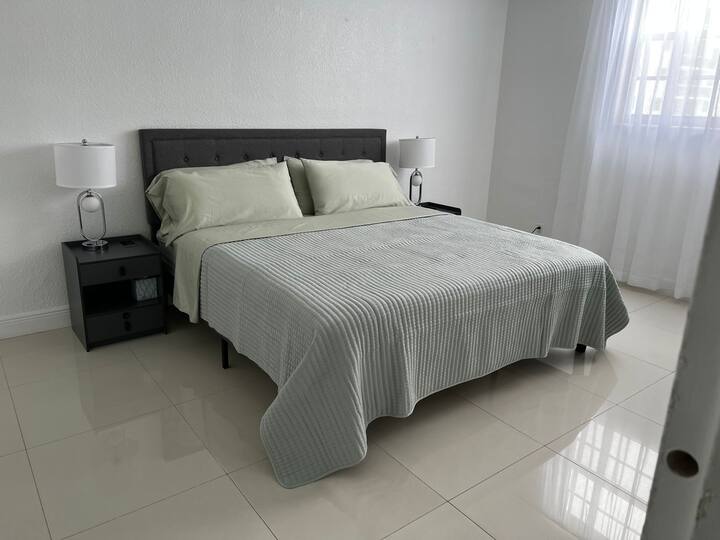 Indulge in our luxurious Master Bedroom with a king-size bed, offering a peaceful retreat for a restful night's sleep during your beachfront getaway.